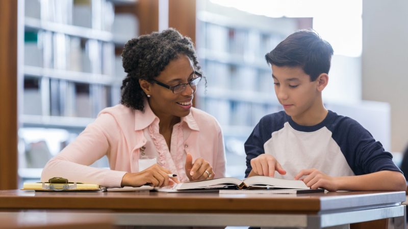 Tutor working with middle school student Tutor working with middle school student