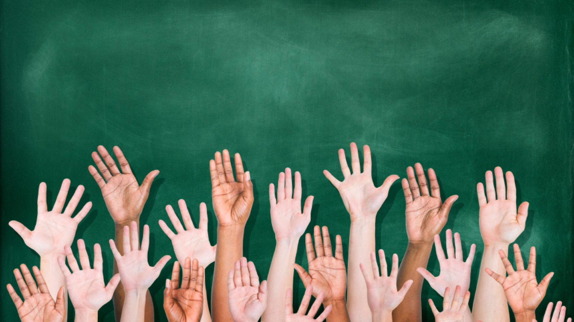 Multiethnic Group of Hands Raised with Blackboard