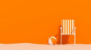 Summer beach holiday travel background chair with beach ball on sand