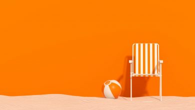 Summer beach holiday travel background chair with beach ball on sand